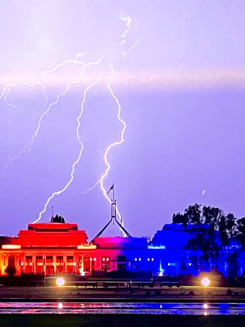 The old Parliament House in Canberra, Australia, lit up in orange for World Cancer Day thanks to ICON Group