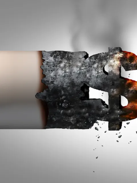 Cigarette end burning with ash forming a dollar sign, emphasising the huge profits generated by the tobacco industry and the heavy influence they use to undermine policy changes and more effective tobacco regulation