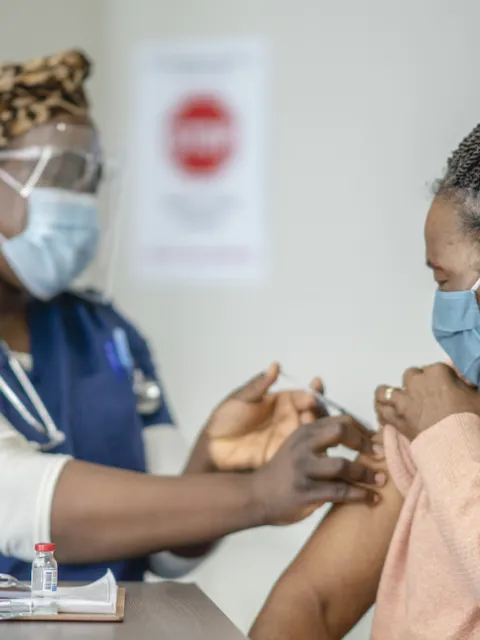 Senior African woman receiving the COVID-19 vaccine