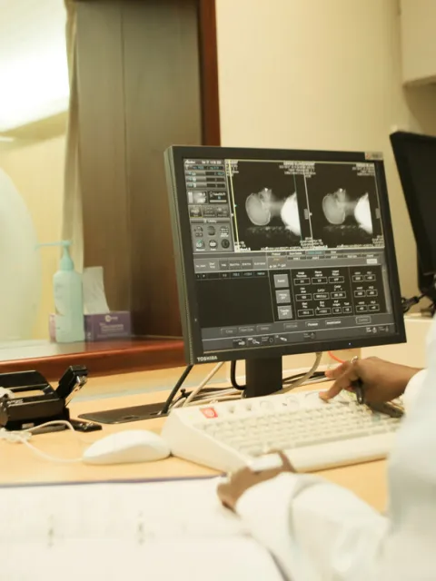 Health worker at Aga Khan University Hospital in Kenya studying MRI scans of a cancer patient