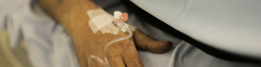 Close-up of a person's hand, receiving treatment intravenously.