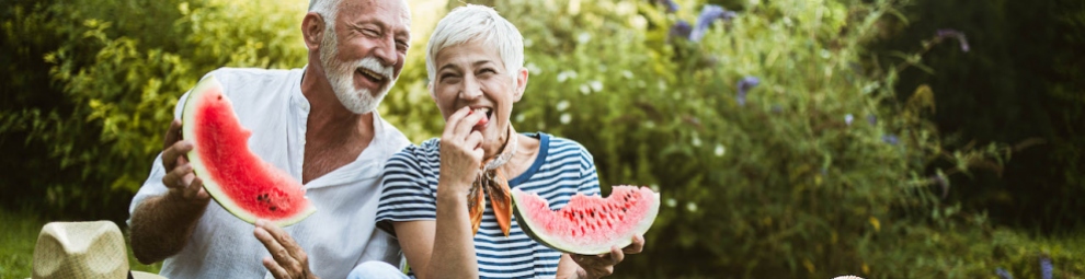 Elderly couple eating watermelon symbolising a healthier lifestyle through nutrition