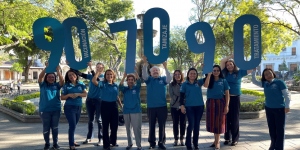 Staff of the Liga Nacional Contra el Cáncer Guatemala holding up number signs to spell out WHO's 2030 targets for cervical cancer elimination: 90, 70, 90