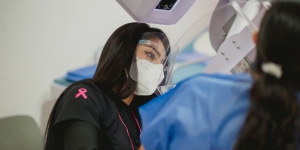 Health care worker at FUCAM in Mexico assists a woman with her mammogram