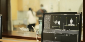 Close up of a image scan of a cancer patient undergoing an imaging examination (MRI), with health practitioners in the background