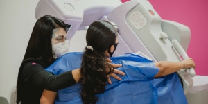 Breast cancer patient being assisted for a mammogram